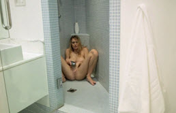 Blonde slut with big tits masturbating in shower